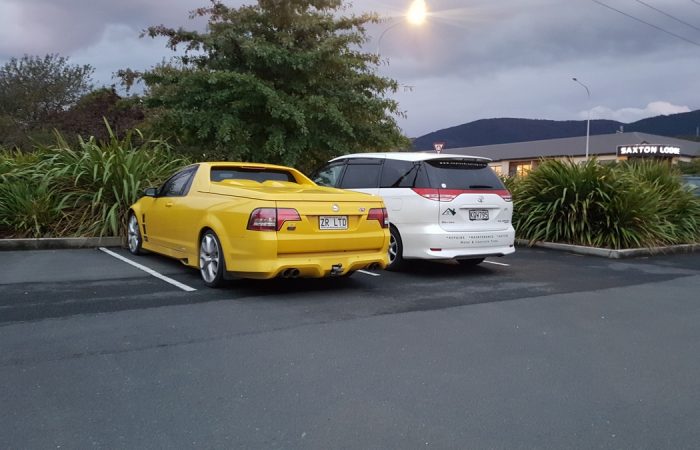 Zealand Roofing Vehciles yellow holden ute and white family wagon